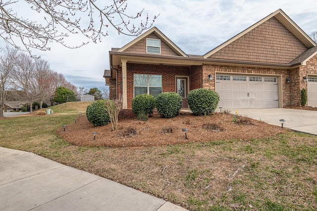 view of front of property with a garage, a front yard, concrete driveway, and brick siding