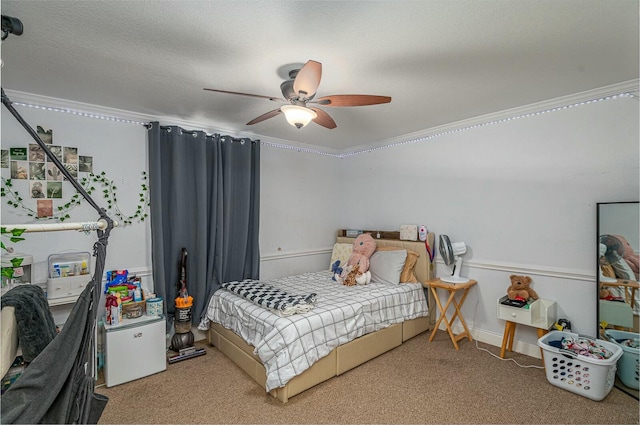 bedroom with a ceiling fan, carpet, ornamental molding, and a textured ceiling