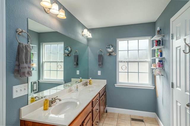 bathroom with a sink, a wealth of natural light, and baseboards