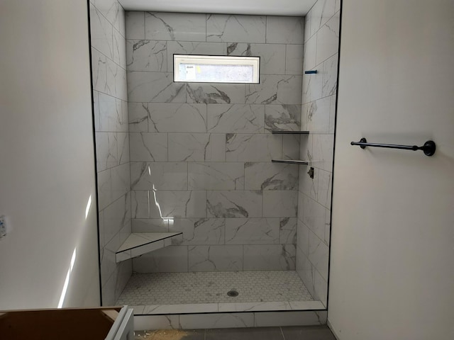 full bath featuring tiled shower