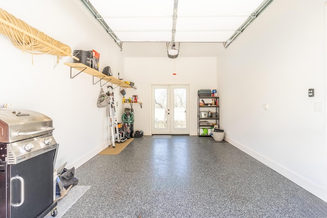 garage featuring baseboards, a garage door opener, and french doors