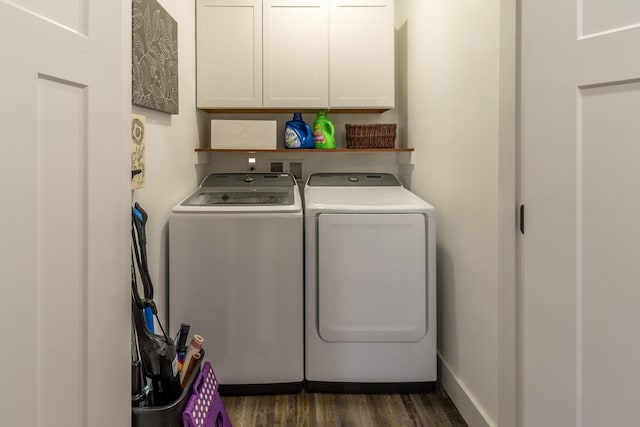 washroom with baseboards, dark wood-style flooring, cabinet space, and washer and dryer