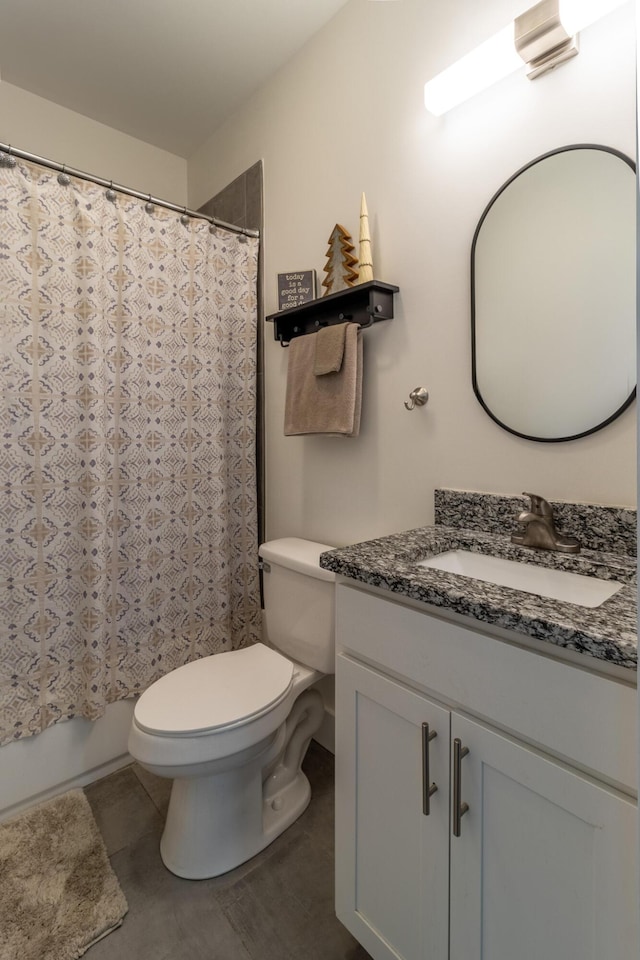 full bathroom featuring toilet, tile patterned floors, and vanity