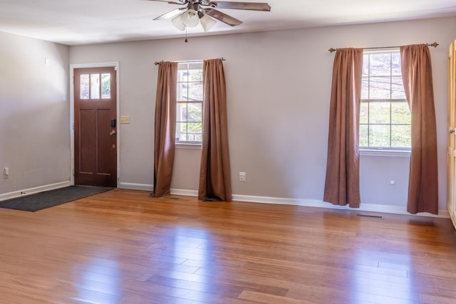 entryway with light wood-style floors, visible vents, ceiling fan, and baseboards