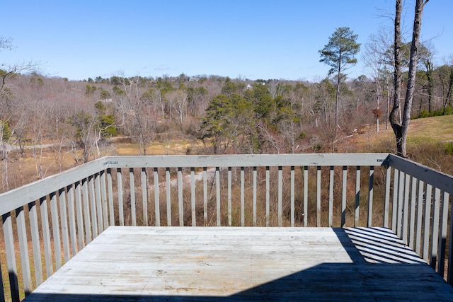 wooden deck featuring a view of trees