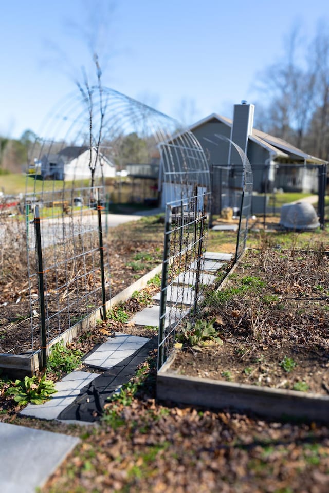 view of yard featuring fence and a garden