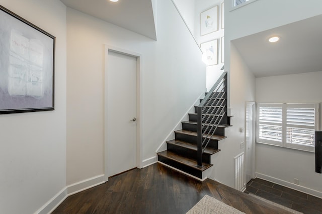 staircase featuring recessed lighting, baseboards, and wood finished floors