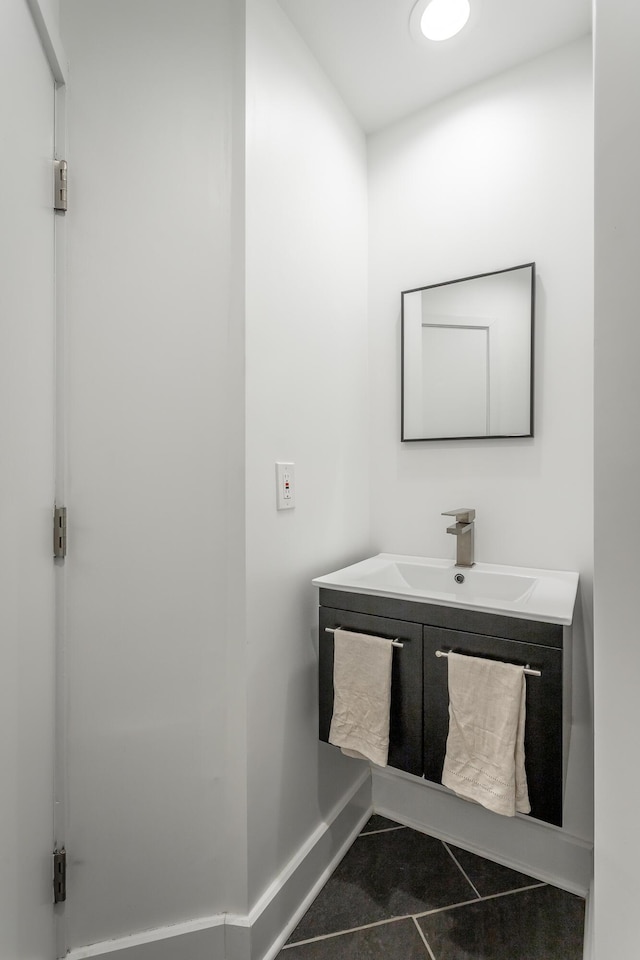 bathroom featuring baseboards, vanity, and tile patterned floors