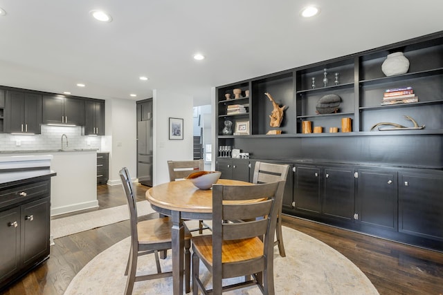 dining area featuring baseboards, dark wood-type flooring, and recessed lighting