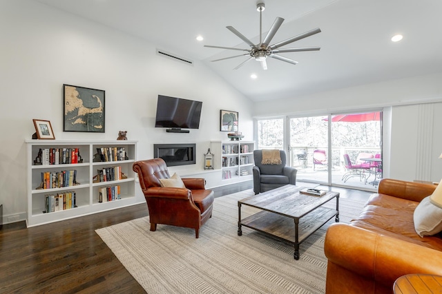 living room with ceiling fan, recessed lighting, wood finished floors, vaulted ceiling, and a glass covered fireplace