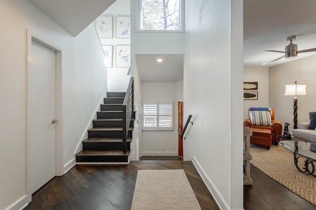 stairway with recessed lighting, wood finished floors, a ceiling fan, and baseboards