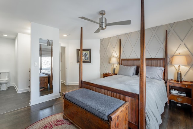 bedroom featuring an accent wall, recessed lighting, baseboards, and wood finished floors