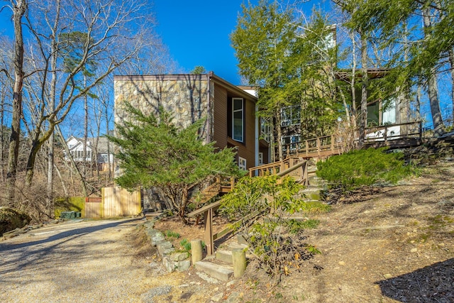 exterior space featuring a wooden deck and stairs