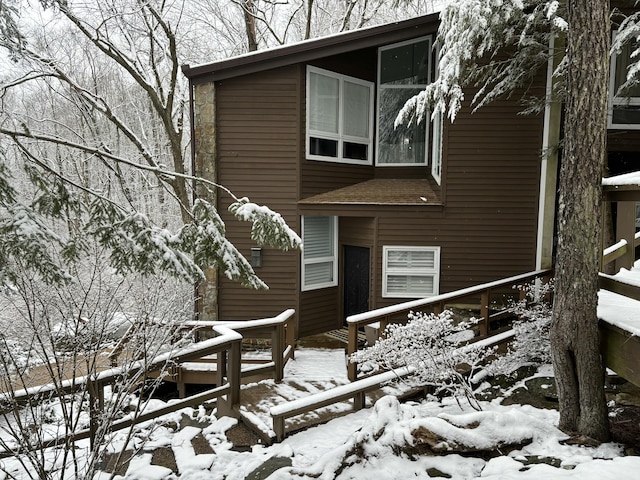 exterior space with roof with shingles