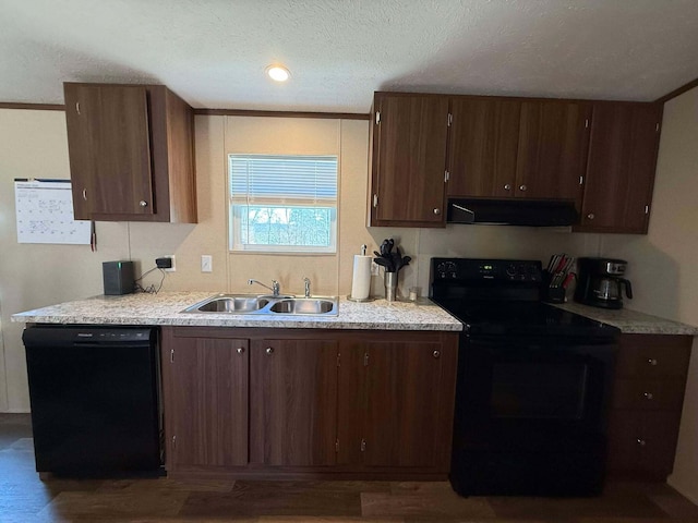 kitchen with light countertops, a sink, under cabinet range hood, and black appliances