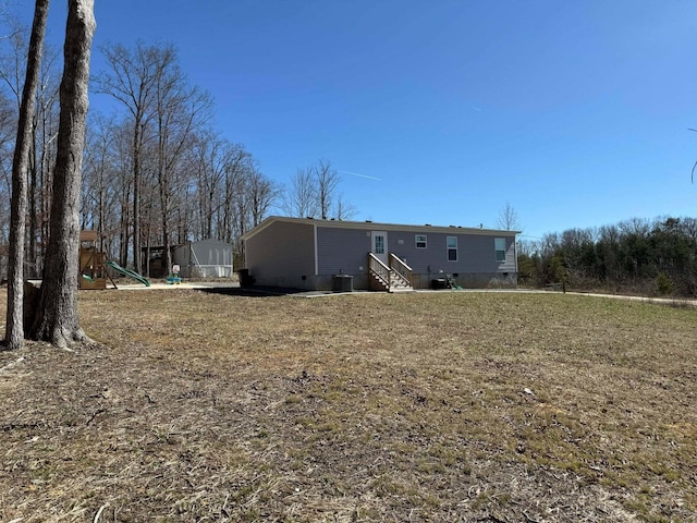 back of house with entry steps, central AC unit, crawl space, and a playground