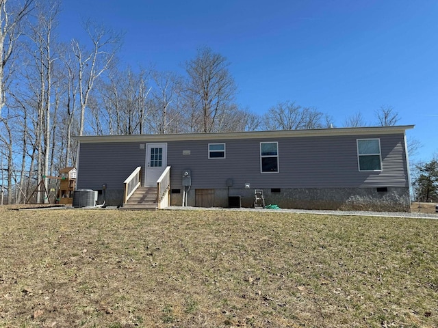 rear view of house with entry steps, crawl space, a lawn, and central air condition unit