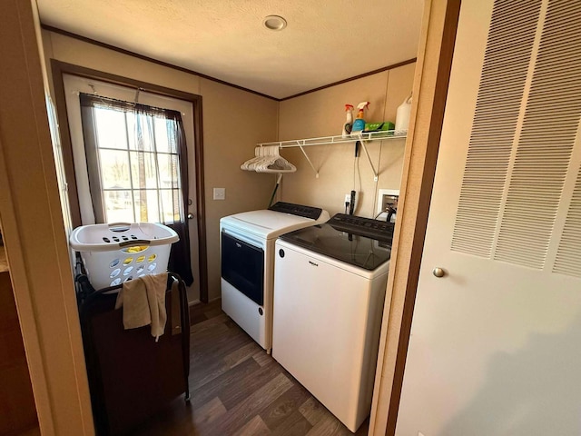 laundry room featuring crown molding, dark wood finished floors, washer and clothes dryer, a textured ceiling, and laundry area