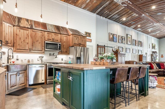 kitchen with finished concrete flooring, wood ceiling, butcher block counters, stainless steel appliances, and a sink