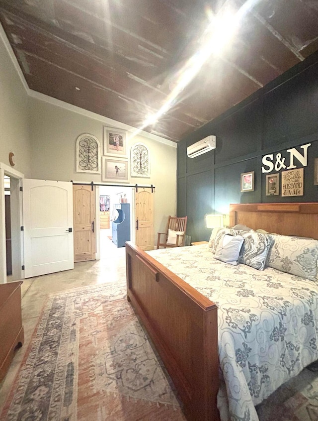 bedroom featuring a wall unit AC and a barn door