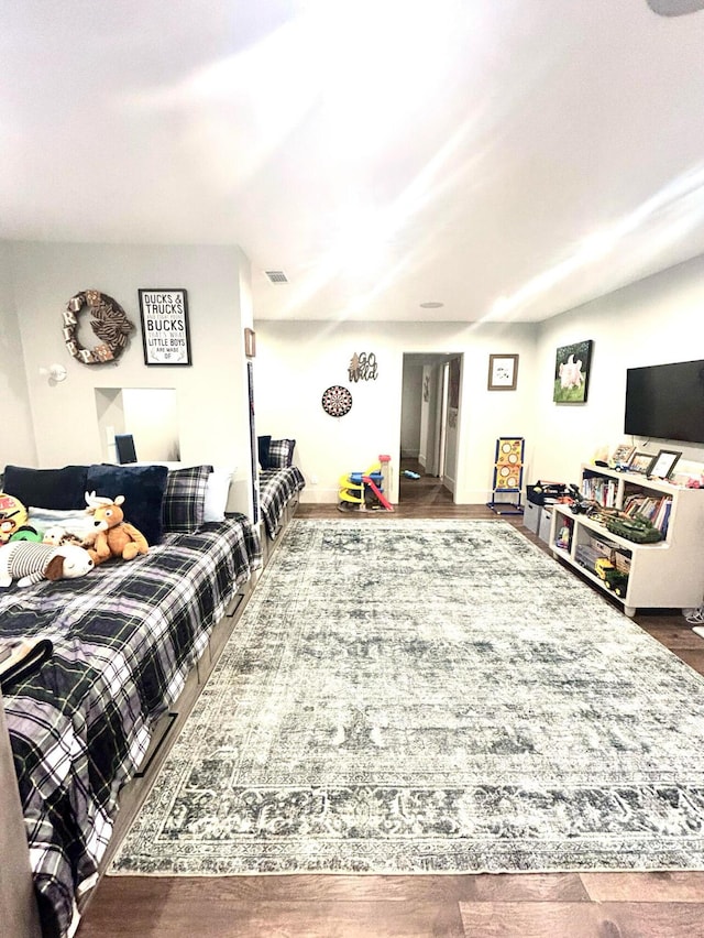 living room featuring wood finished floors and visible vents