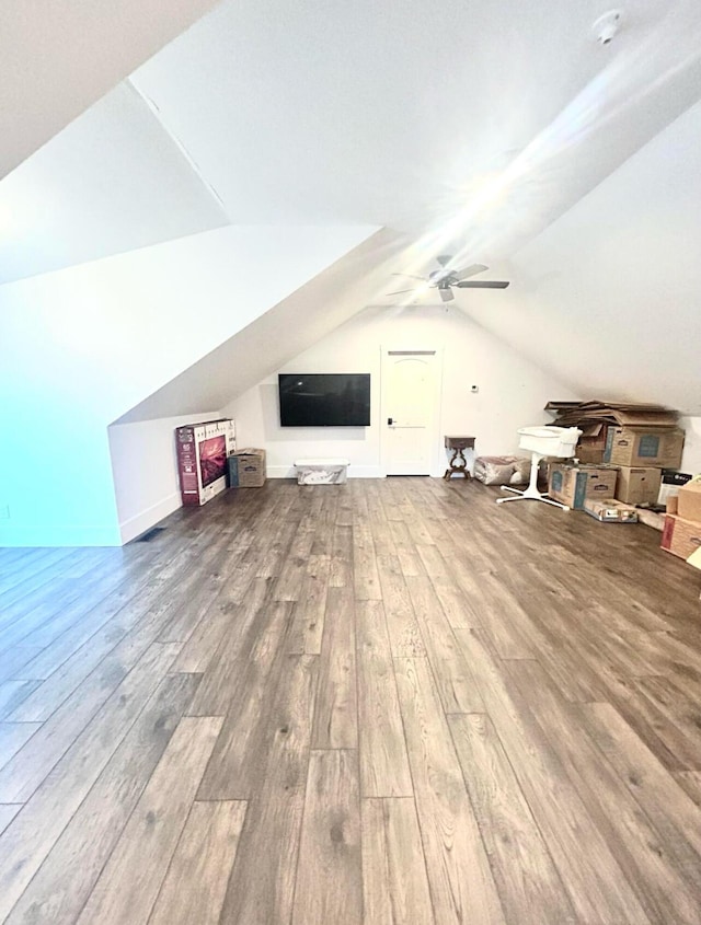 bonus room with lofted ceiling, wood finished floors, and a ceiling fan