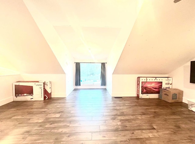 bonus room featuring lofted ceiling and wood finished floors