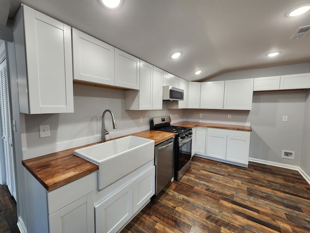 kitchen with visible vents, butcher block countertops, a sink, and appliances with stainless steel finishes