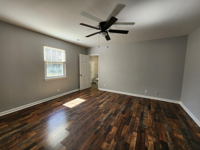 unfurnished bedroom with a ceiling fan, dark wood finished floors, and baseboards