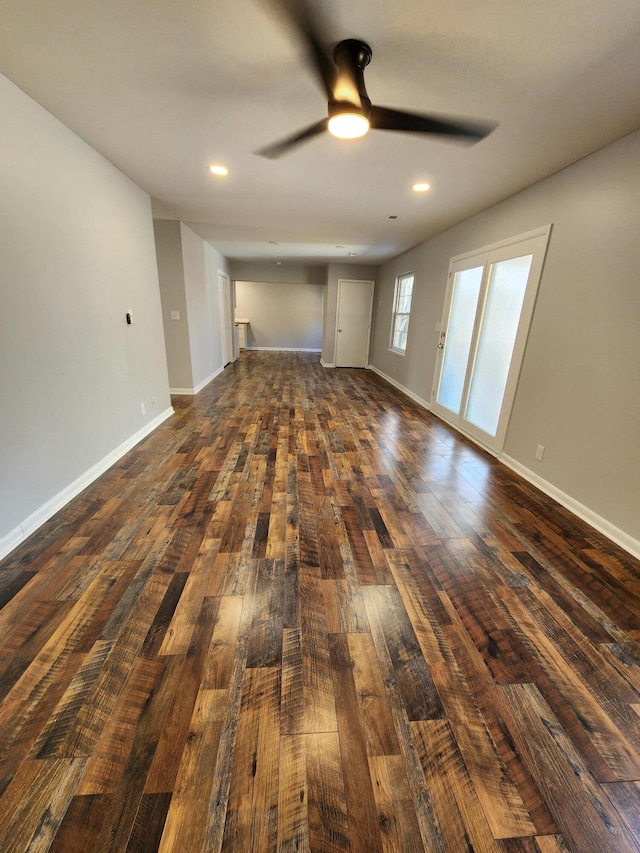 unfurnished living room with ceiling fan, dark wood-type flooring, recessed lighting, and baseboards