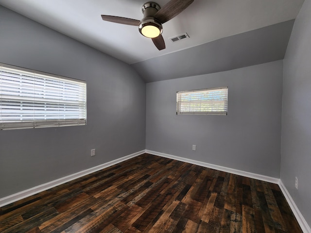 unfurnished room with baseboards, visible vents, a ceiling fan, lofted ceiling, and dark wood-style floors