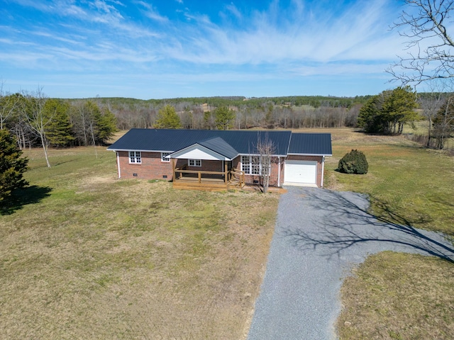 view of front of property featuring metal roof, a garage, crawl space, a front lawn, and gravel driveway