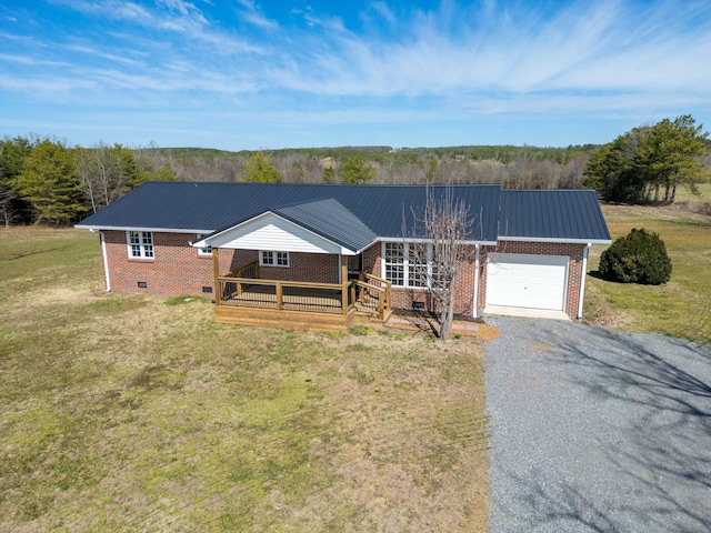 ranch-style home with metal roof, a garage, brick siding, crawl space, and a front yard