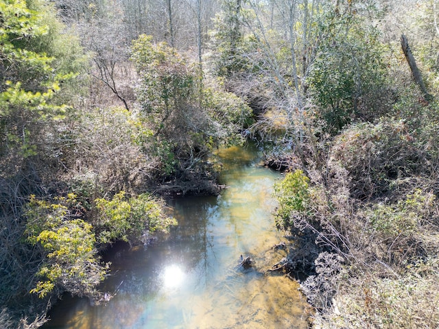 drone / aerial view with a wooded view