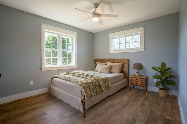 bedroom featuring ceiling fan, baseboards, and wood finished floors