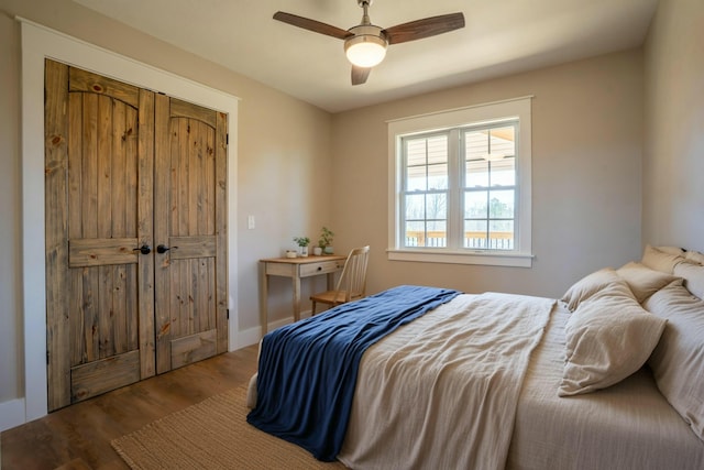 bedroom featuring a closet, wood finished floors, and a ceiling fan