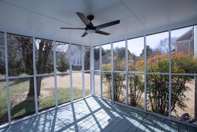 unfurnished sunroom with plenty of natural light and a ceiling fan