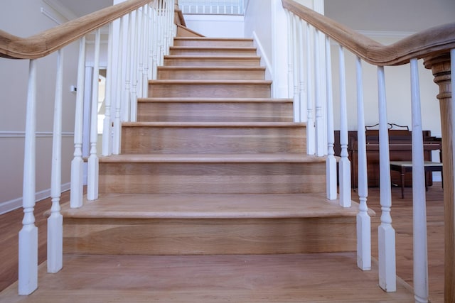 stairway featuring wood finished floors