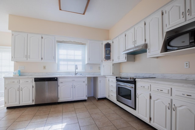 kitchen featuring under cabinet range hood, appliances with stainless steel finishes, white cabinets, and a sink