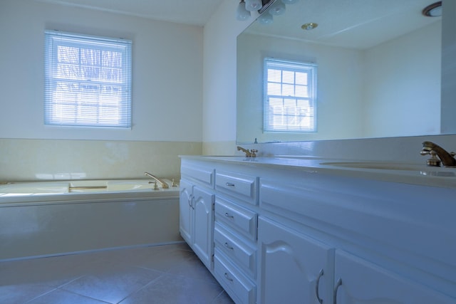 full bathroom with double vanity, a sink, a bath, and tile patterned floors