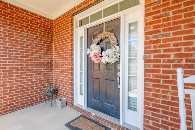 view of exterior entry with brick siding