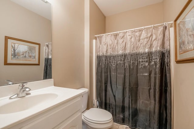 bathroom with curtained shower, vanity, and toilet