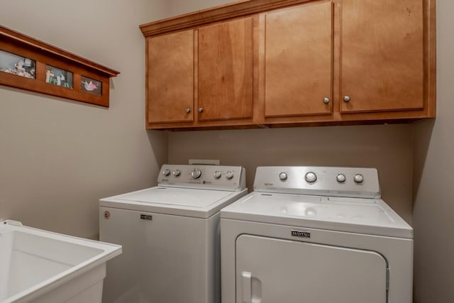 laundry room featuring cabinet space, a sink, and independent washer and dryer