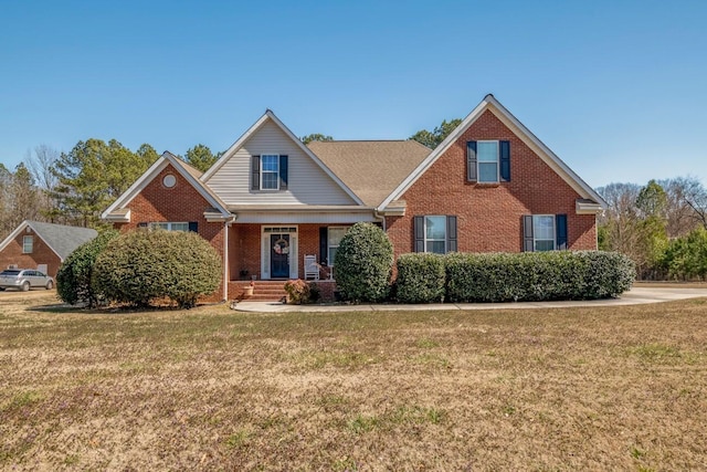 view of front of property featuring brick siding and a front yard