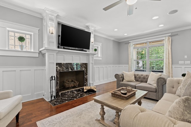 810 Boylston St, Chattanooga, TN 37405 - living room featuring a decorative wall, wood finished floors, a wainscoted wall, crown molding, and a ceiling fan