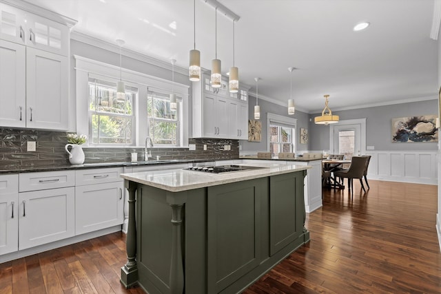 810 Boylston St, Chattanooga, TN 37405 - kitchen featuring a peninsula, black electric stovetop, crown molding, dark wood-style flooring, and white cabinets