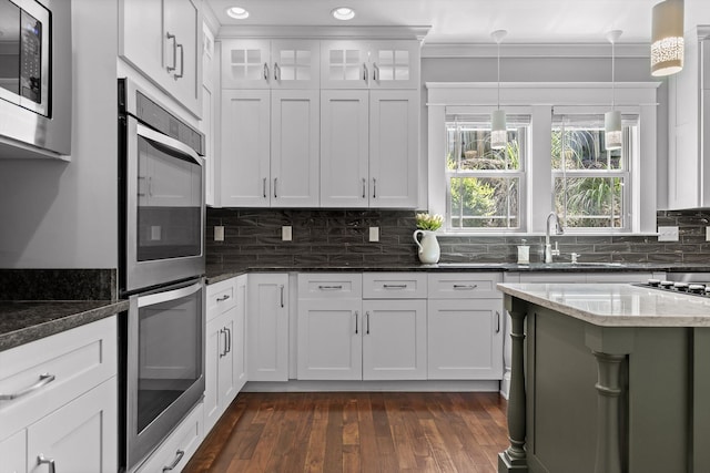 810 Boylston St, Chattanooga, TN 37405 - kitchen with stainless steel appliances, ornamental molding, dark stone countertops, pendant lighting, and white cabinets