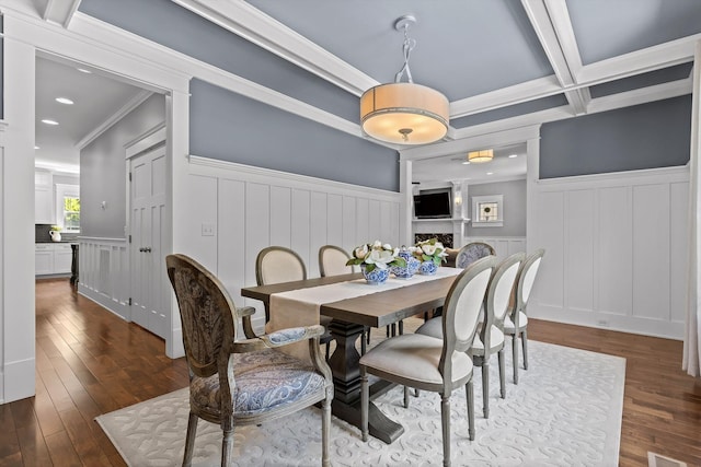 810 Boylston St, Chattanooga, TN 37405 - dining space with wainscoting, a decorative wall, dark wood-style flooring, crown molding, and a fireplace