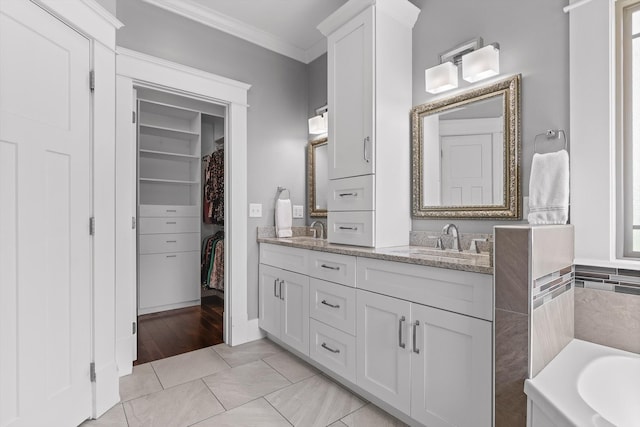 810 Boylston St, Chattanooga, TN 37405 - bathroom with crown molding, double vanity, a spacious closet, a garden tub, and tile patterned flooring