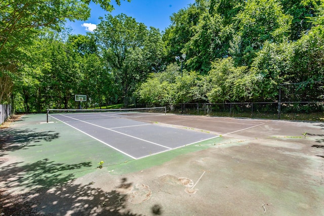 view of tennis court featuring fence